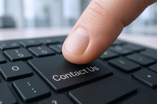 Finger pressing Contact Us button on a computer keyboard, customer service concept for digital communication photo