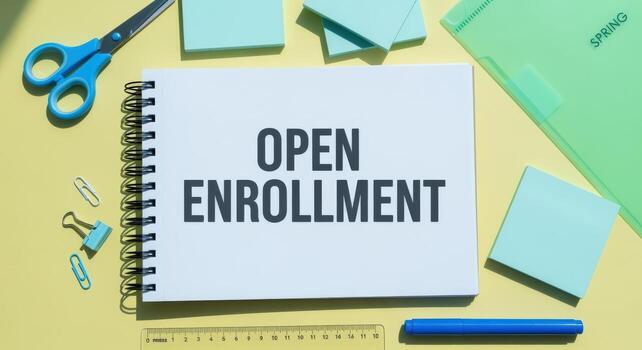 Open Enrollment Announcement on Notepad with Office Supplies and Pastel Background for Business Communication photo