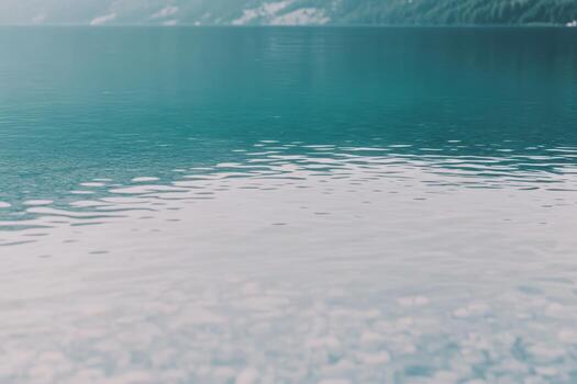 Calm turquoise water reflecting mountains in a serene natural setting photo