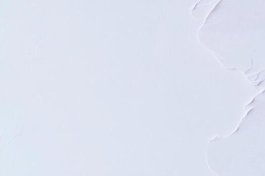 Smooth white surface with minimal texture appearing in natural light photo