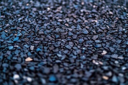 Detailed close-up of textured asphalt surface with gravel particles visible photo