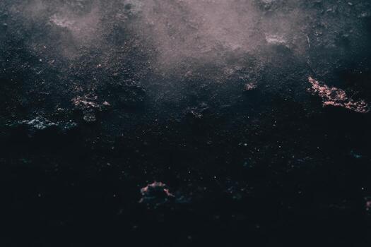 Dark surface with textures and dust particles in subtle light photo