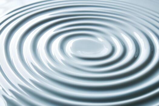 Smooth surface of water with concentric ripples created by a drop photo