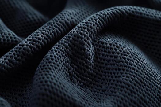 Close-up view of textured dark fabric showcasing intricate mesh pattern photo