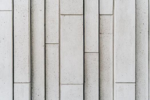 Textured concrete wall with vertical panels in modern architecture design photo