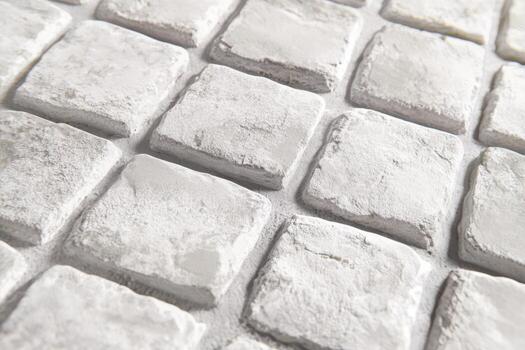 White textured stone tiles arranged in a geometric pattern for flooring photo