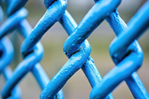 Close-up view of shiny blue chain link fence showcasing textured design photo