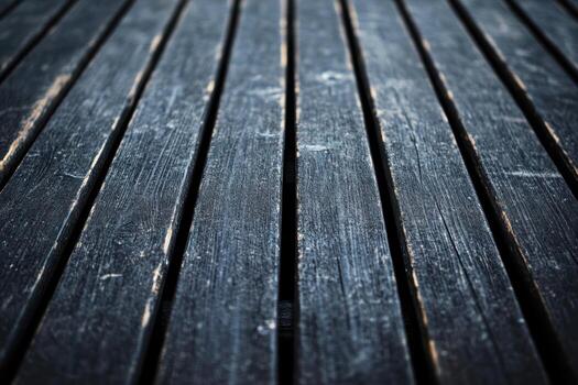 Textured wooden planks on a dark surface create a rustic appearance photo