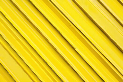 Bright yellow industrial surface with diagonal lines creating texture photo