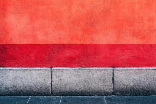 Bright red wall with smooth stone base on a sunny day in a city photo