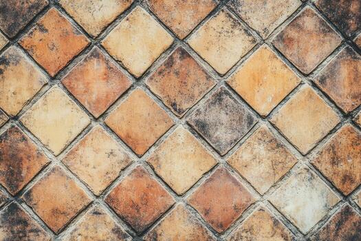 Textured tiled wall with warm earth tones and diamond patterns in daylight photo