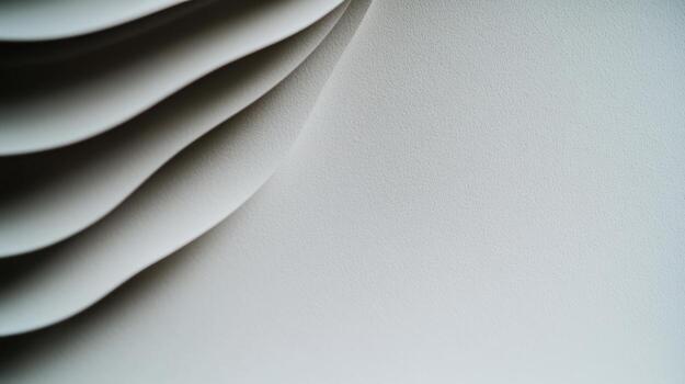 Elegant white paper stack showcasing smooth curves and textures photo