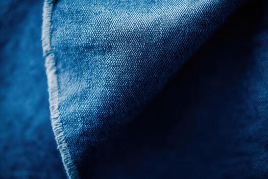 Close-up view of textured blue denim fabric showcasing its weave patterns photo