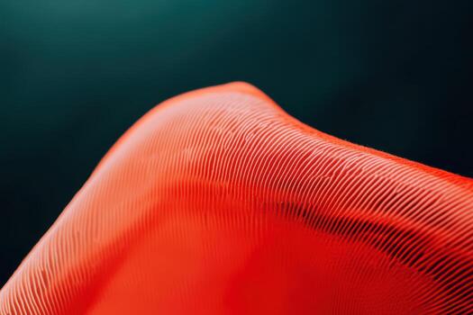 Close-up view of a textured red fabric against a dark background photo