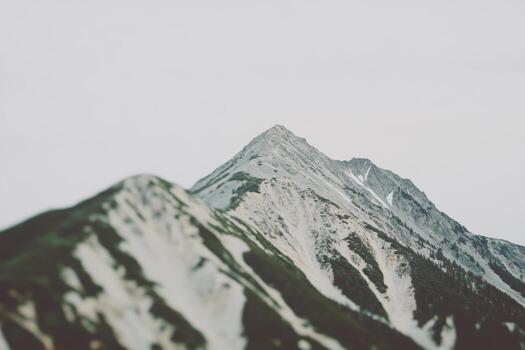 Majestic mountain peaks under a cloudy sky in a remote location photo