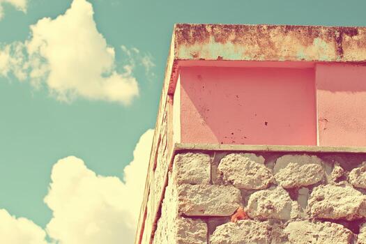 Wall detail against a bright sky with clouds in a vintage style setting photo