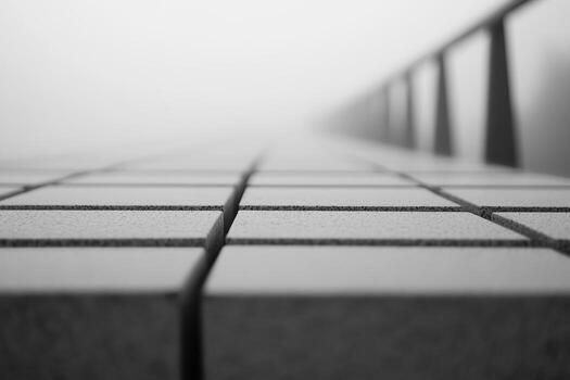 A low-angle view captures a stone-tiled pathway that stretches into thick fog photo