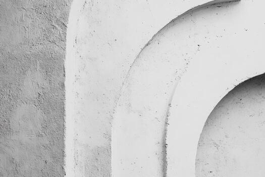 Architectural details of curved concrete wall structure in monochrome photo