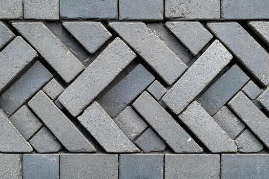 Intricate pattern of gray paving stones arranged in a crisscross design photo