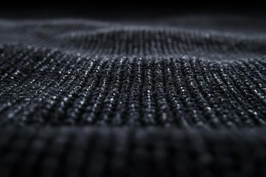Close-up view of textured black fabric displaying intricate weave patterns photo