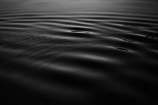 Calm water surface reflects subtle ripples under soft light photo