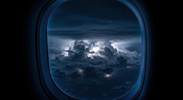 Dramatic lightning storm seen through an airplane window with dark turbulent clouds photo