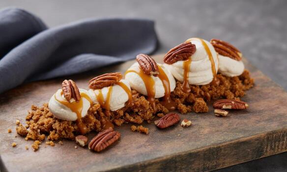 Deconstructed carrot cake dessert with creamy frosting, caramel drizzle, and pecan nuts photo