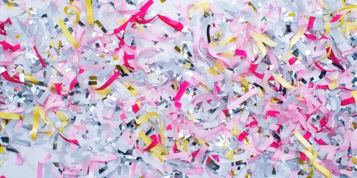 Colorful confetti background with ribbons and scattered elements for a festive event. photo