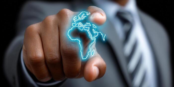 Businessman pointing at a glowing world map representing global business. photo