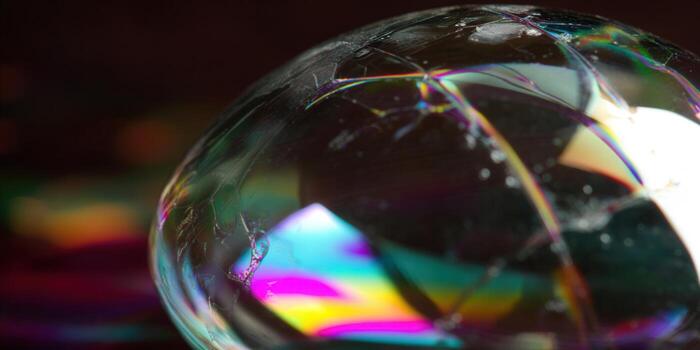 Close-up of a soap bubble, displaying beautiful iridescent colors and intricate textures. photo