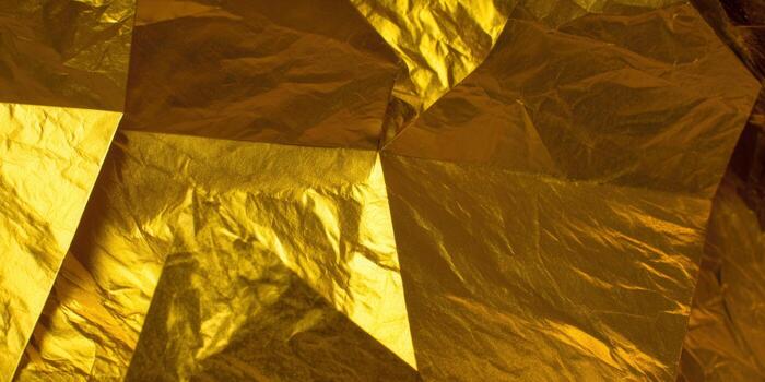 Gold foil texture with geometric patterns, creating a luxurious background. photo