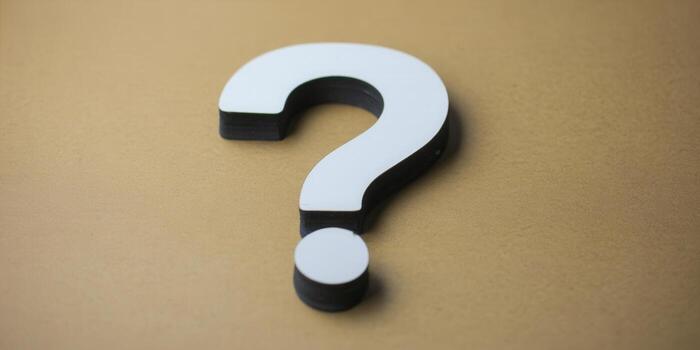 A clean and minimalist shot of a question mark, ready for your queries. photo