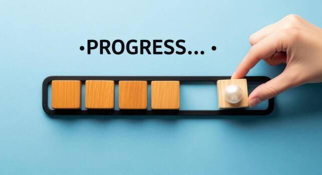 Hand completing progress bar with wooden blocks, showcasing business growth and development on blue background photo