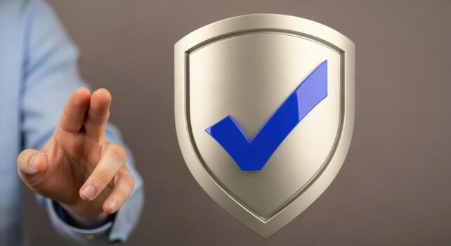 Shield with Check Mark Held Up by Hand, Concept of Protection, Safety, or Approval photo