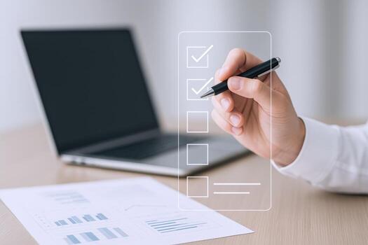 Completing Digital Checklist on Transparent Interface with Pen and Laptop, Modern Office Setting, Business Concept photo