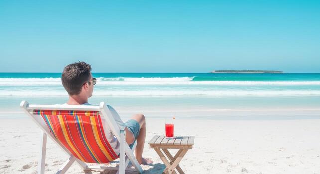 Man Relaxing on Beach Chair Enjoying Tropical Vacation with Drink and Scenic Ocean View photo