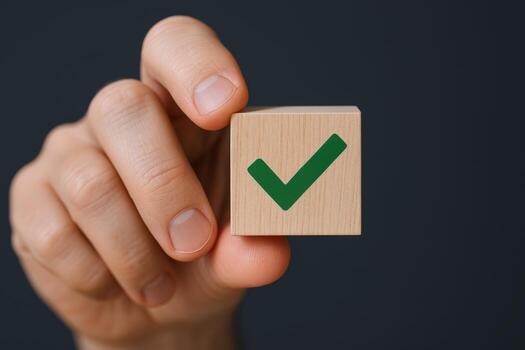 Hand Holding Wooden Cube with Green Check Mark Symbol on Dark Background, Concept of Agreement photo