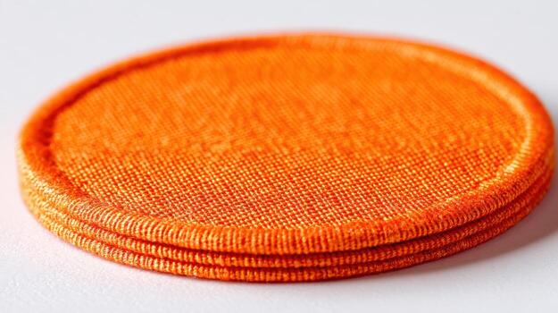 Close-up of a Stack of Vibrant Orange Woven Fabric Patches, Ideal for Crafts and Design photo