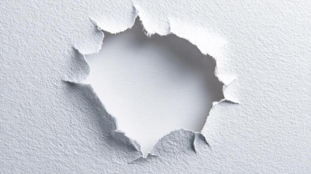 Torn White Paper with a Hole Revealing a Bright Center, Ideal for Design Overlays and Backgrounds photo