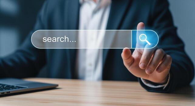 Businessman using search engine with finger, laptop on desk, internet technology concept, and data photo