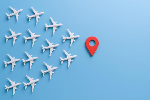 Aerial Fleet Convergence White Airplane Models Flying Towards Red Location Pin on Blue Background photo