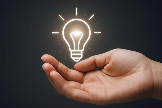 Illuminating Ideas A Hand Offering a Glowing Light Bulb Representing Innovation and Creative Thinking photo