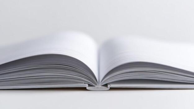 Open blank book with white pages against a white background in a close-up shot photo