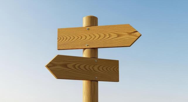 Wooden Directional Signpost with Two Arrows Against a Clear Sky Suggesting Choice and Navigation photo