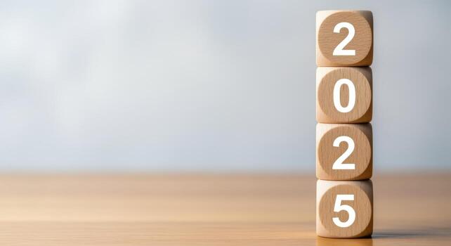 Wooden Blocks Stacked to Display 2025, Symbolizing the New Year and Future Goals on a Wooden Table photo