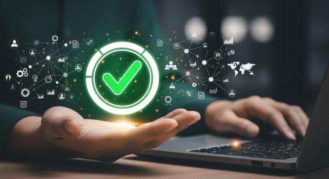 Online Approval Concept Person Using Laptop with Green Check Mark Symbolizing Success photo