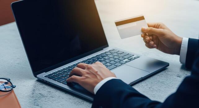 Online Transaction Businessman Using Laptop and Credit Card for Secure Digital Payment and Shopping photo