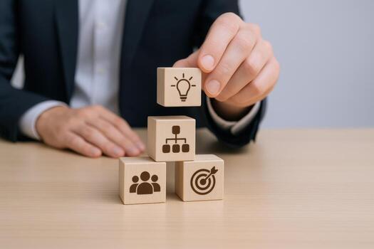 Business Strategy Hand Stacking Wooden Blocks with Idea, Management, Team and Target Icons photo