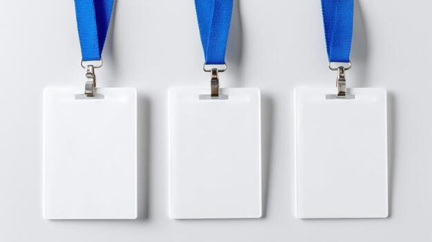 Three Blank White Identification Badges with Blue Lanyards on a Neutral Background for Corporate or Event Use photo