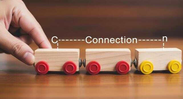 Building Connections Hand Assembling Wooden Toy Train on Wooden Surface, Concept of Partnership and Collaboration photo